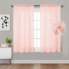 a pink curtain hanging on the side of a wall next to a white dresser and window