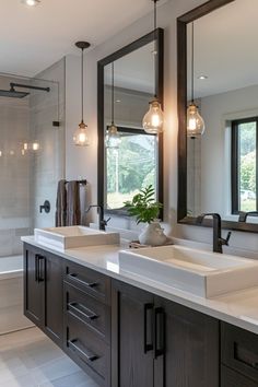 a large bathroom with double sinks and mirrors