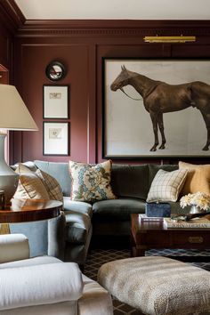 a living room filled with furniture and pictures on the wall