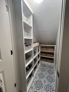 a walk in closet with shelves and baskets