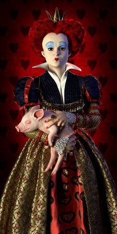 a woman with red hair and makeup holding a pig in her arms on a red background