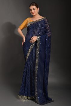 Product Features: Saree Color: Blue Blouse Color: Blue Saree Fabric: Soft Georgette Blouse Fabric: Soft Georgette Work: Blue Wash: Dry Clean Occasion: Party Product Type: Saree Disclaimer: There will be slight difference in digital to actual image Blue And Yellow Saree, Stone Saree, Sequins Saree, Reception Saree, Party Wear Sarees Online, Lace Fancy, Sequence Saree, Sequin Saree, Latest Indian Saree