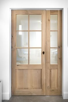 a wooden door with glass panels in a room