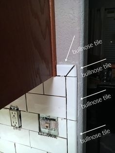 the corner of a kitchen with an electrical outlet in it's wall and labeled parts