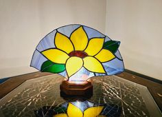 a stained glass lamp sitting on top of a table