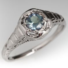 This charming vintage ring features a pierced design and is accented with one (1) round mixed cut natural alexandrite weighing 0.35 carat and bead set into an octagonal shaped setting. The ring measures 8.1mm at the top, rises 5.2mm above the finger, tapering to 1.3mm wide and 1.0mm thick at the base of the shank. This ring is currently a size 6.25 and shows gentle overall wear. Formal Art Deco Birthstone Jewelry, Vintage Rings With Octagon Center Stone, Vintage Octagon Ring With Center Stone, Antique Sapphire Birthstone Ring For Formal Occasions, Formal Faceted Emerald Ring, Elegant Faceted Sapphire Promise Ring, Elegant Octagon Solitaire Sapphire Ring, Elegant Sapphire Faceted Rings, Elegant Sapphire Rings With Faceted Detail