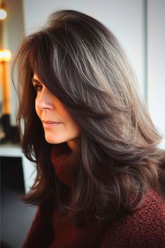 Rich mocha waves with layers and feathered ends offer a classic look with a twist. The deep brown layers create a dimensional and voluminous style, perfect for any occasion. Click here to see more stunning long hairstyles for women over 60. Dark Brunette Hair, Haircuts For Medium Length Hair, Hairstyles For Women Over 50, Undercut Pixie