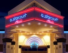 the entrance to a starcourt hotel lit up at night