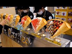 people wearing masks are buying ice cream at a store