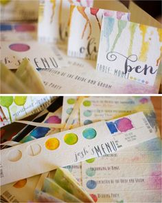 some paper tags with watercolor paint on them