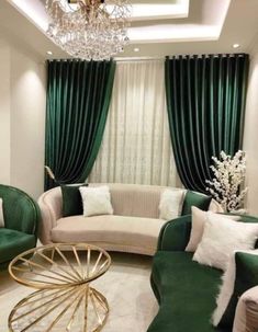 a living room filled with green couches and white pillows on top of a rug