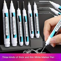 a person holding a pen in front of six different sized toothbrushes with instructions on how to use them