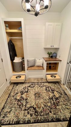 a room with a rug and some cabinets