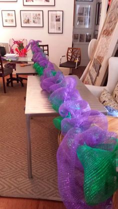 purple and green ribbons on a table in a living room