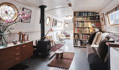 a living room filled with furniture and bookshelves next to a fire hydrant