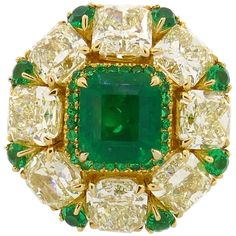 Sparkly and colorful cocktail ring that is a great addition to your jewelry collection. It is made of 18 karat (stamped) yellow gold and features a gorgeous 2.24-carat finest color emerald framed with a row of eight light fancy yellow radiant cut diamonds slightly over 1.0-carat each (VS clarity, total weight approximately 8.28 carats). The shank tastefully accented with round faceted emeralds (0.83 carat total), intense fancy yellow round brilliant diamonds (0.24 carat total) and white round br Gold Ring Design, Antique Emerald Ring, Cocktail Chic, Yellow Gold Cocktail Ring, Colorful Cocktails, Yellow Diamonds, Gold Cocktail Ring, Gold Cocktail, Emerald Color