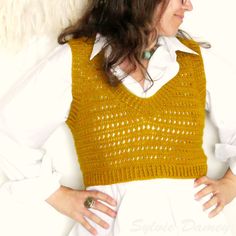 a woman wearing a yellow sweater and white shirt