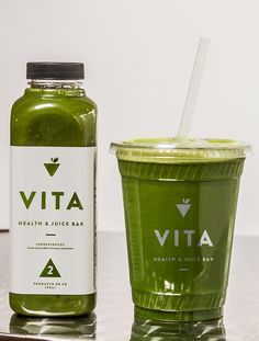 a green smoothie next to a bottle of vita