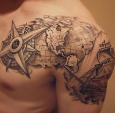 a man's chest with a map and compass tattoo on it