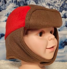 Brown and Red Accent Children's Winter Hat This hat is right on trend with today's fashion for children. It's fun, fashionable, warm and cozy and perfect to wear on a cold winter's day. The hat is made with anti pill fleece. Straps close with velcro.  -Perfect cold weather fashion accessory to keep you warm cozy and stylish -This hat will be a perfect cold weather accessory for any cold outdoor. -For all occasions and three seasons - winter spring and fall. This hat is soft and comfortable for a Playful Brown Winter Hat, Red Bonnet For Winter, One Size Fits Most, Red Winter Bonnet, One Size Fits Most, Red Winter Bonnet (one Size Fits Most), Red Warm Outdoor Hat, Warm Red Hat For Outdoor, Warm Red Outdoor Hat, Playful Warm Hats For Outdoor, Fun Winter Hats For Cold Weather