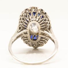 The Mila ring is a handmade engagement ring. It centers one antique oval very rare, elongated diamond of D color, SI2 clarity that weighs 1.72ctw. The center stone is surrounded by 22 natural calibrated French cut sapphires that weigh 2.50ctw. Thirty old mine cut diamonds of H color VS1 clarity that weigh 1.30ctw surrounded the sapphires in a second halo. This ring is currently size 8 and can be sized. Ring measurement: 23mm by 14mm Total weight: 3.9 dwt/ 6.1 grams Handmade Engagement Ring, Doing The Right Thing, Handmade Engagement Rings, French Cut, Engagement Ring Diamond Cut, Sapphire Engagement Ring, Sapphire Diamond Ring, Onyx Ring, Metal Clay