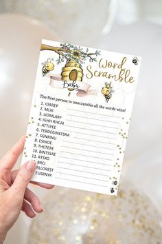 a hand holding up a word scramble card with gold foil confetti around it