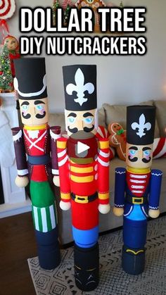 three wooden nutcrackers sitting in front of a christmas tree