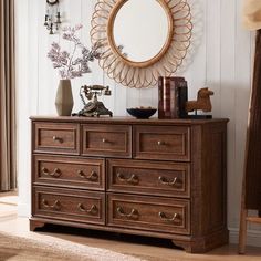 a dresser with drawers and a mirror above it