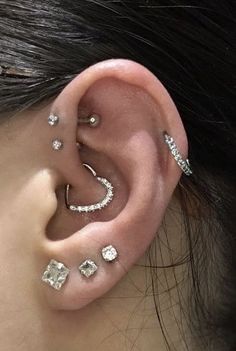 a woman with three different piercings on her ear