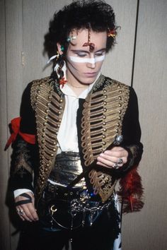 a man with makeup on his face is dressed in costume