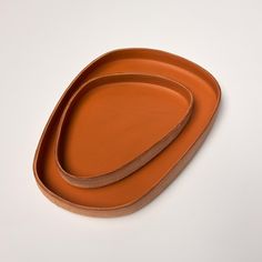 three orange plates sitting on top of each other