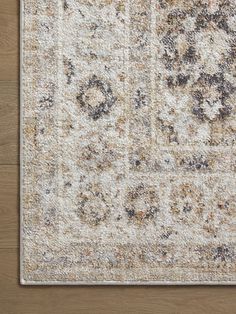 an area rug is shown on the floor with wood floors and a wooden wall in the background