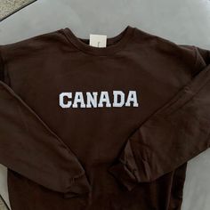 This very comfy and trendy CANADA sweatshirt is perfect for lounging in this cozy fall and winter season! This is also perfect for gifting to your loved ones! Please note that the letters are patches and are heat pressed, NOT embroidered. Purchasing this means you are aware and accept that. Our sweatshirts run in a UNISEX fit. The sweaters naturally have a slightly oversized fit giving extra room for moving around and comfort! For this reason, we highly recommend getting your true normal size es Retro Brown Crew Neck Sweatshirt, Cozy Crew Neck Top With Letter Print, Brown Relaxed Fit Sweatshirt With Letter Print, Relaxed Fit Brown Sweatshirt With Letter Print, Brown Cotton Sweatshirt With Letter Print, Cozy Crew Neck T-shirt With Letter Print, Canada Sweatshirt, Canadian Gifts, Custom Crewneck Sweatshirts