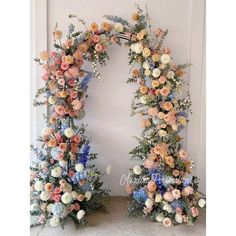 two floral archways are decorated with blue, pink and orange flowers in the center