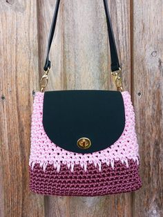 This handmade crochet bag is my creative work, lovingly crafted by hand. It is a perfect choice for those who love urban style, color, and minimalism. The small pink purse is made from high-quality polyester cord and features faux leather details, including the bottom, flap, and top handle. The harmonious combination of rose, burgundy, and black colors makes this compact handbag a versatile accessory that will complement any outfit. This handbag is compact, lightweight, yet sturdy. It's the perf Pink Crochet Bags For Everyday Use, Pink Square Crochet Bag For Everyday Use, Pink Square Crochet Bag For Everyday, Pink Crossbody Crochet Bag For Everyday Use, Pink Square Crochet Bag For Gift, Pink Crochet Bag As Gift, Pink Crochet Bag For Gift, Pink Crochet Bag With Adjustable Strap For Everyday Use, Hand Knitted Pink Bags For Gifts