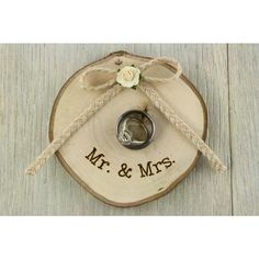 two wedding rings tied to a wooden slice with the word mr and mrs on it