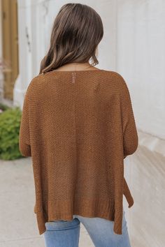 This sweater is expertly crafted for ultimate comfort and style! The Ultimate Loose Fitted Sweater in Brown boasts a wide neckline and 3/4 sleeves with permanent rolled cuffs. Fashioned from a soft and durable knit material, this loose fit sweater also features side slits for added flair. Made with 65% acrylic and 35% nylon for a cozy and luxurious feel. Style with jeans, ankle booties, a wide brim hat, and matching accessories for a chic fall outfit! Casual Solid Cardigan With 3/4 Sleeves, Casual Solid Color 3/4 Sleeve Cardigan, Knit Sweater With 3/4 Sleeves, Textured Knit Top With Batwing Sleeves For Fall, Casual Knit Sweater With 3/4 Sleeve, Brown Batwing Sleeve Sweater For Fall, Casual 3/4 Sleeve Sweater For Layering, Solid Color 3/4 Sleeve Sweater For Spring, Layering Cardigan With 3/4 Sleeve