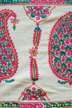 an embroidered cloth with colorful designs on it