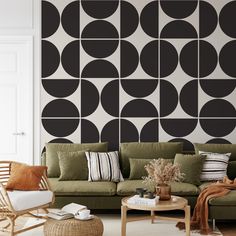 a living room filled with furniture next to a wall covered in black and white circles