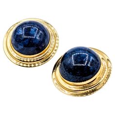 Statement Gold & Cabochon Lapis Clip On Earrings Unveiling our elegant clip-on earrings, a blend of classic charm and modern finesse. Delicately crafted in 14k yellow gold, these earrings are adorned with a 15mm cabochon Lapis centerpiece. The vivid Lapis, known for its deep blue allure, stands as the highlight of this design. Measuring at a refined size of 21.5x21.5mm and weighing 9.3g, these earrings are both substantial and comfortable. Should you desire a custom fit, size adjustments are readily available upon request. Elevate your ensemble with a touch of vintage elegance. The Sumerians believed that the spirit of their gods lived within the stone, while the ancient Egyptians saw it as a symbol of the night sky. Since the earliest of times, lapis lazuli has been associated with royalt Ancient Egyptian, Deep Blue, Lapis Lazuli, Clip On, Custom Fit, Clip On Earrings, Jewelry Earrings, Yellow Gold, Stone