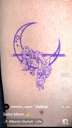 a tattoo on the back of a woman's arm with an angel and moon