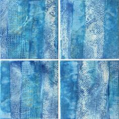 four different pictures of blue and white paint on the same sheet of paper, each with an abstract design