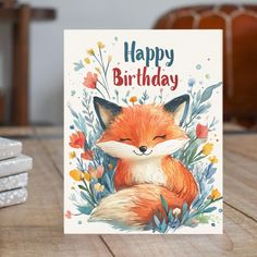 a happy birthday card with an image of a fox on the front and flowers in the back