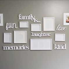 a wall with many different frames and pictures on it that say family, love, laughter, and kind