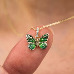 What do Butterflies symbolize? Dance Like the Butterfly Butterflies bring color and joy with them. They awaken a sense of lightness and joy. They can symbolize purity, love, grace, lightness of being, dignity, good luck, hope and unpredictability. 💕DETAILS The Green Butterfly is 1cm x 1.3cm 💕 WITH A CHAIN ---> Chain is 14k solid gold ---> The necklace can be removed from the chain. ---> The gold chain is 45cm long (approx. 18in). ---> The chain used is 0.8mm - 10mm thick (approx. 0.031in -0.04 Green Butterfly Charm Necklace, Elegant Green Butterfly Necklace, Green Jewelry With Butterfly Charm For Gift, Green Butterfly Jewelry For Gifts, Green Butterfly Jewelry For Gift, Elegant Green Butterfly Necklace As Gift, Elegant Green Butterfly Necklace For Gift, Elegant Green Butterfly Necklace Perfect For Gifts, Butterflies Symbolize