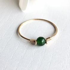 This beautifully simple ring is lovingly handmade with a Jade gemstone and a choice of 14k Gold Filled, 14k Rose Gold Filled or Sterling Silver band. M A T E R I A L S: * Dark Green Jade * 14k Gold Filled, 14k Rose Gold Filled or Sterling Silver S I Z E: * Gemstone - Approximately 4mm * Band Thickness - Approximately 0.8-1mm All of our jewellery is carefully handmade using good quality materials and handpicked gemstones, with the aim to produce quality pieces that you can love & wear for years t Minimalist Handmade Rings For May Birthstone, Minimalist Handmade Rings With May Birthstone, Minimalist Handmade May Birthstone Rings, Handmade 14k Gold Rings For May Birthstone, Green Jewelry With Simple Design As Gift, Simple Green Jewelry For Gifts, Simple Green Jewelry Gift, Green Simple Design Jewelry For Gift, Green Simple Design Jewelry Gift