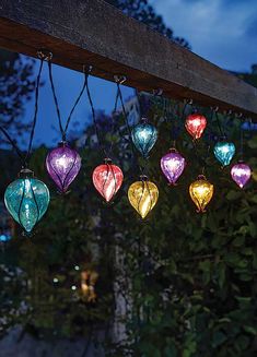 multicolored lights hanging from a wooden beam