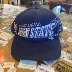 This piece is a vintage snapback hat from the 1990s for the Penn State Nittany Lions best known for their football team. This embroidered baseball cap has a big shadow spell out across the front in the well known Sports Specialties design and logos on either side for the team.  -80% Acrylic, 20% Wool -No major stains, yellowing or flaws Please also assess the photos carefully using your own personal judgement on the condition of the item as we do not accept returns.  **All hats are shipped FLAT Nittany Lion, Embroidered Baseball Caps, Penn State, Boyfriend Birthday, Vintage Sports, Vintage Sweaters, Snapback Hats, Hats Vintage, Football Team