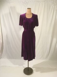 "vintage 1940s handmade dress solid purple  soft velvet side zip- metal TALON side belt loops matching sash tie belt scoop neck w/pleats good vintage condition, light wear measures, lying flat, shoulder-14 1/2\" chest-18 1/2\" waist-12\" hip-18\" to 19\" sleeve-9\" top shoulder to waist-16\" total length-44 1/2\"     We do not offer returns or refunds unless something is grossly misrepresented. Please contact us within 2 business days of receiving to discuss any possible returns for this reason. We do not offer refunds for your shipping fees. Please feel free to contact us with any questions you may have about an item prior to purchase and we will gladly answer them." Purple 50s Dress, Side Belt, Purple Soft, Vintage 40s, Handmade Dress, Scoop Neck Dress, 1940s Dresses, Purple Blouse, Sash Belt