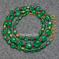 "DESCRIPTION: Thank you for coming in! Breath-taking Zambian emerald in the most beautiful and vibrant blue green color and with gem clarity which give it a glowing look you can only find in the best material! Decorated with the finest ruby rondelles and diamond accent! Made with 18k yellow gold and diamond findings! These are treasures you can collect and pass down through generations! Emeralds are even more valuable than diamonds because pure Emerald is very rare and is out numbered greatly by Fine Jewelry Green Emerald Necklace, Green Tsavorite Gemstone Jewelry, Green Round Emerald Necklace With Gemstone Accents, Round Green Emerald Necklace With Gemstone Accents, Green Emerald Necklace With Gemstone Accents, Green Tsavorite Emerald Necklace, Luxury Green Gemstone Beaded Jewelry, Green Oval Fusion Jewelry, Green Multi-stone Emerald Necklace Gift